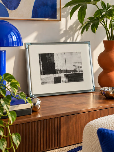 silver aluminum poster frame displayed in a bright interior