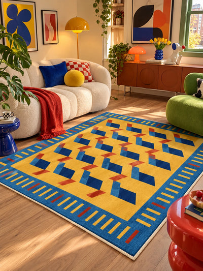 Marigold geometric rug between a curved cream sofa and green armchair with wood credenza