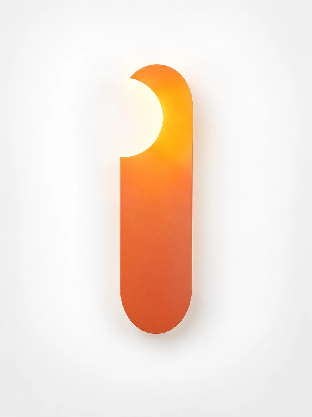 
Orange minimalist wall lamp with warm glowing shade, studio shot