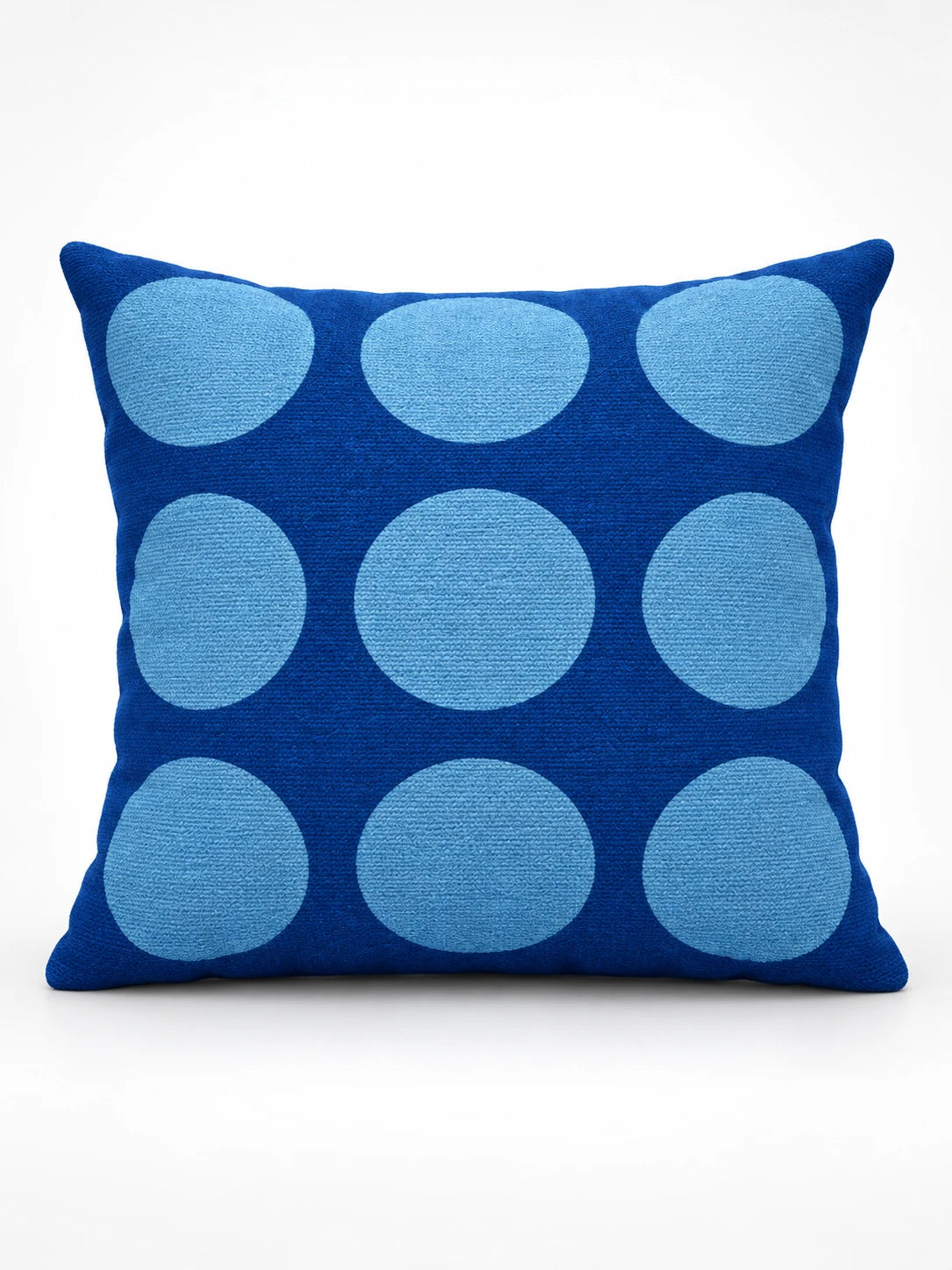 
royal blue throw pillow with a grid of large light blue dots, studio view