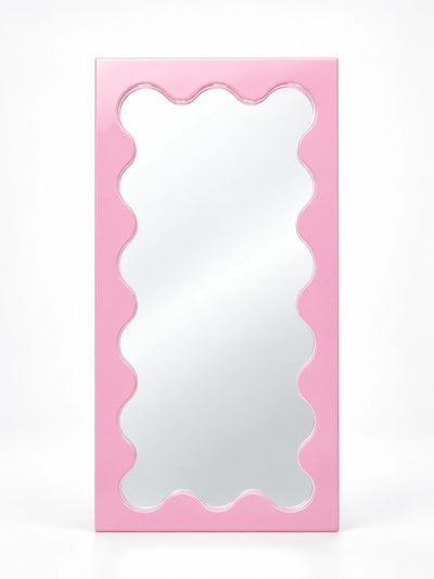 Pink solid wood vanity mirror with wavy scalloped inner frame, studio shot